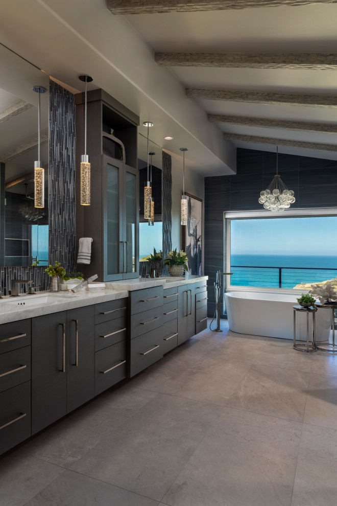 Large trendy blue tile and porcelain tile porcelain tile, gray floor, double-sink and exposed beam bathroom photo in Orange County with flat-panel cabinets, gray cabinets, gray walls, an undermount sink, marble countertops, a hinged shower door, white countertops and a floating vanity