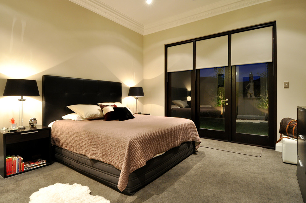 Photo of a large contemporary master bedroom in Perth with beige walls and carpet.