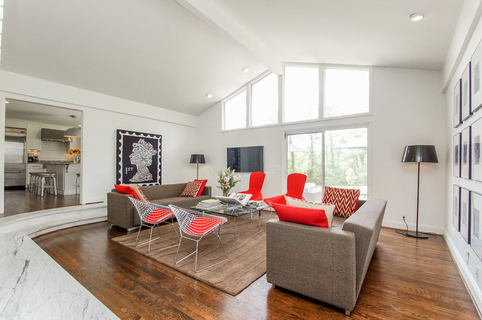 Example of a mid-sized trendy enclosed dark wood floor family room design in Nashville with white walls, a wall-mounted tv and no fireplace