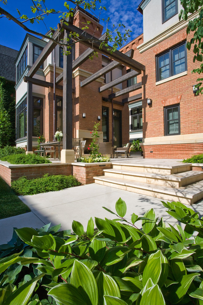 This is an example of a small contemporary backyard garden in Chicago with natural stone pavers.