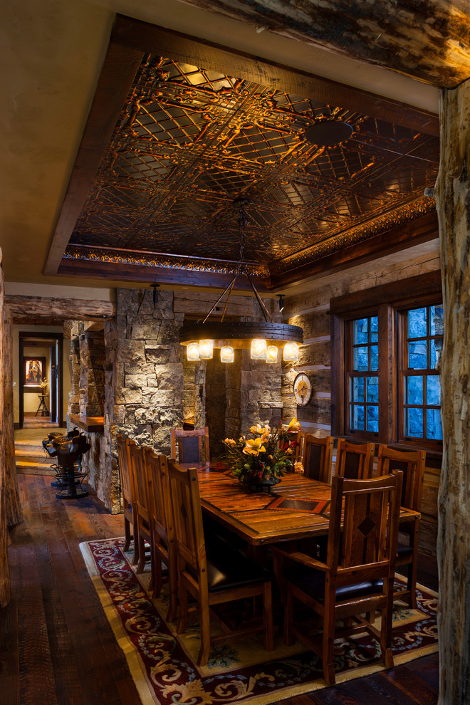 Country dining room in Denver with dark hardwood floors.