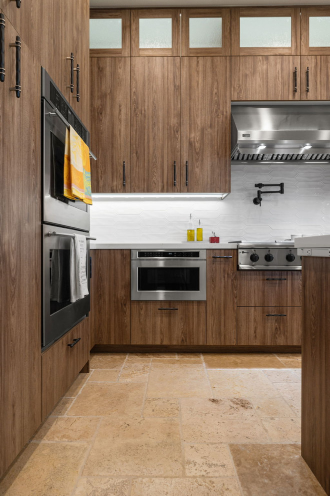 Enclosed kitchen - rustic l-shaped slate floor and beige floor enclosed kitchen idea with a single-bowl sink, flat-panel cabinets, medium tone wood cabinets, quartzite countertops, white backsplash, glass sheet backsplash, stainless steel appliances, a peninsula and white countertops
