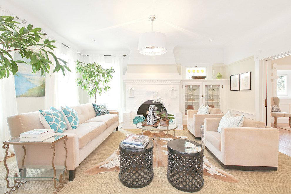 Photo of a large traditional living room in San Francisco with beige walls and a standard fireplace.