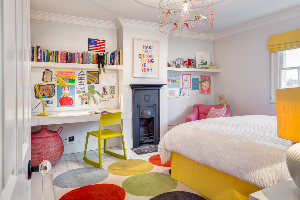 This is an example of a traditional kids' bedroom for girls in London with grey walls and painted wood floors.