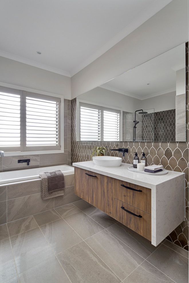 Beach style master bathroom in Other with medium wood cabinets, brown tile, an open shower and white benchtops.