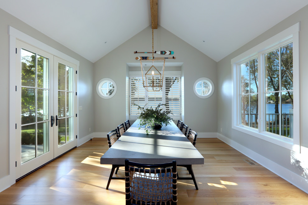 Inspiration for a large traditional dining room in Grand Rapids with grey walls and light hardwood floors.