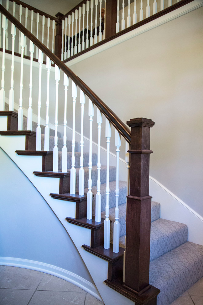 Photo of a mid-sized traditional carpeted curved staircase in Kansas City with carpet risers.