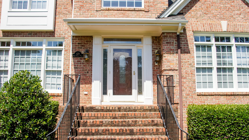 Design ideas for a mid-sized traditional front door in Charlotte with white walls, medium hardwood floors, a single front door and a dark wood front door.