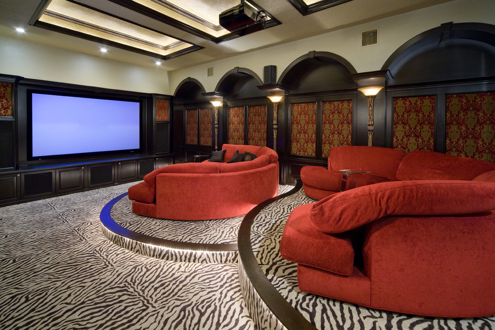 Photo of a traditional enclosed home theatre in Orlando with carpet, a projector screen and multi-coloured floor.