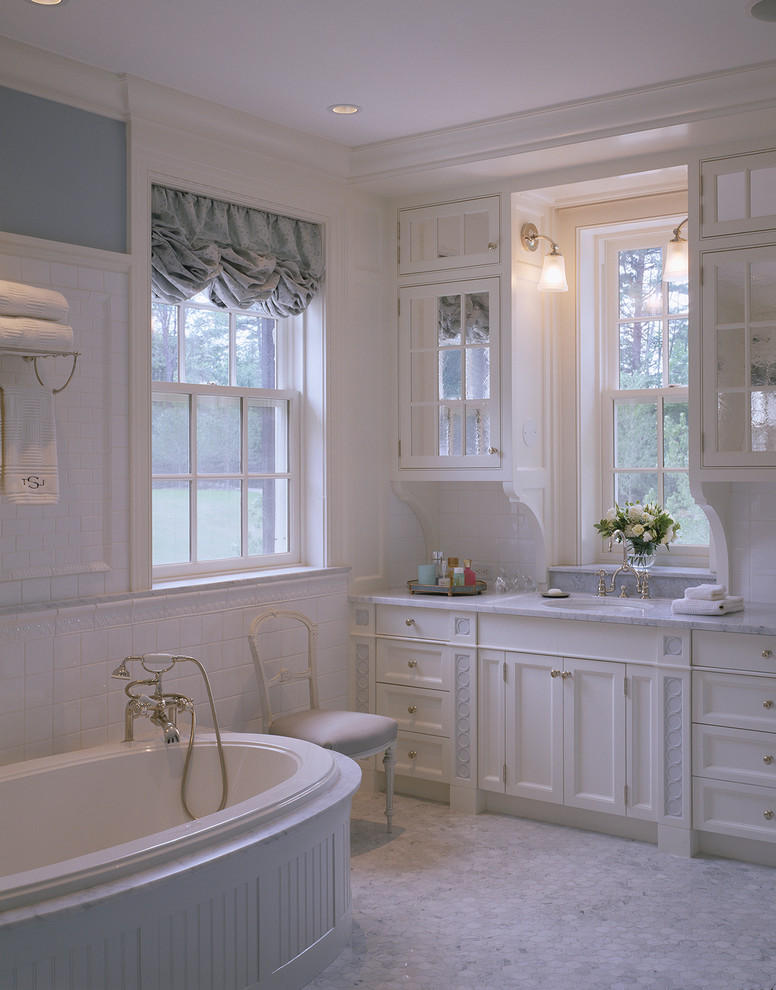 Inspiration for a traditional bathroom in Boston with an alcove tub, recessed-panel cabinets and an undermount sink.