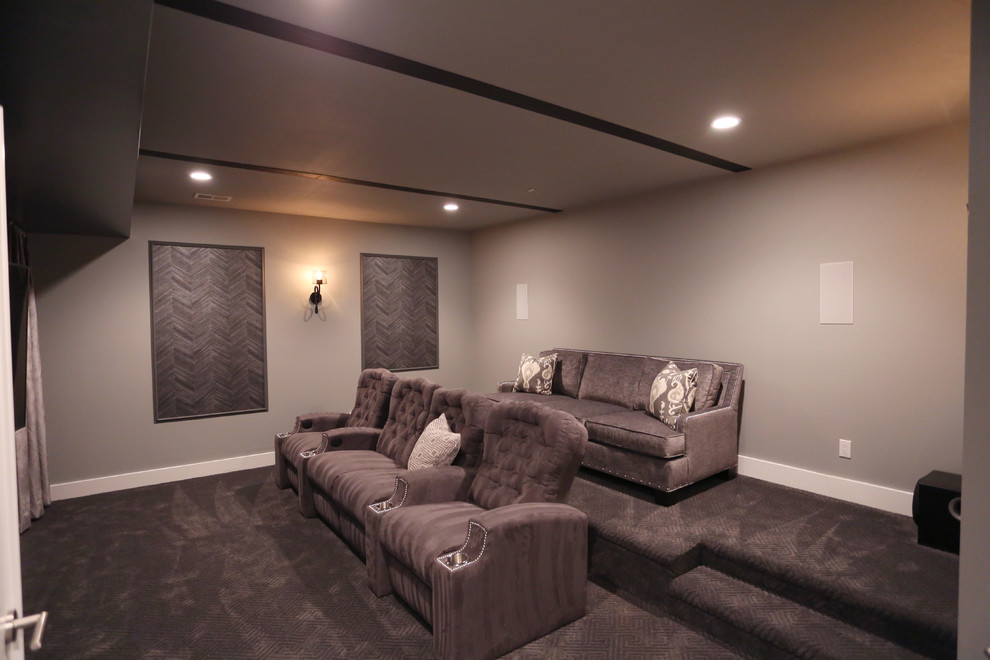 Mid-sized enclosed home theatre in DC Metro with grey walls, carpet, a wall-mounted tv and grey floor.