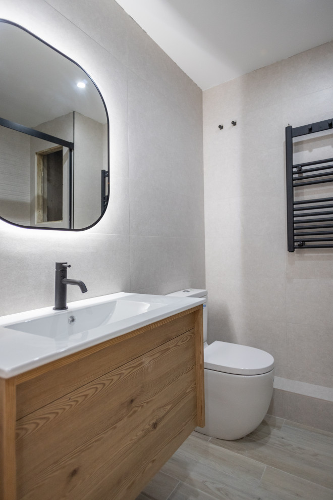 Photo of a mid-sized mediterranean master bathroom in Barcelona with flat-panel cabinets, medium wood cabinets, an alcove shower, a one-piece toilet, gray tile, ceramic tile, a trough sink, brown floor, a hinged shower door, white benchtops, an enclosed toilet, a single vanity and a floating vanity.
