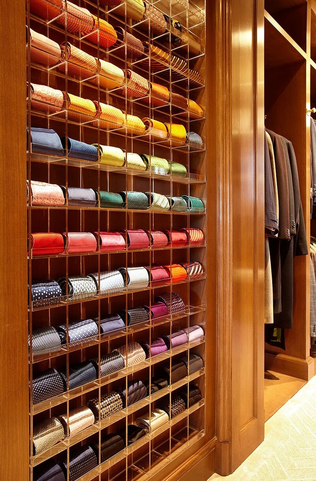 Inspiration for a large traditional men's walk-in wardrobe with flat-panel cabinets, light wood cabinets, carpet and beige floor.