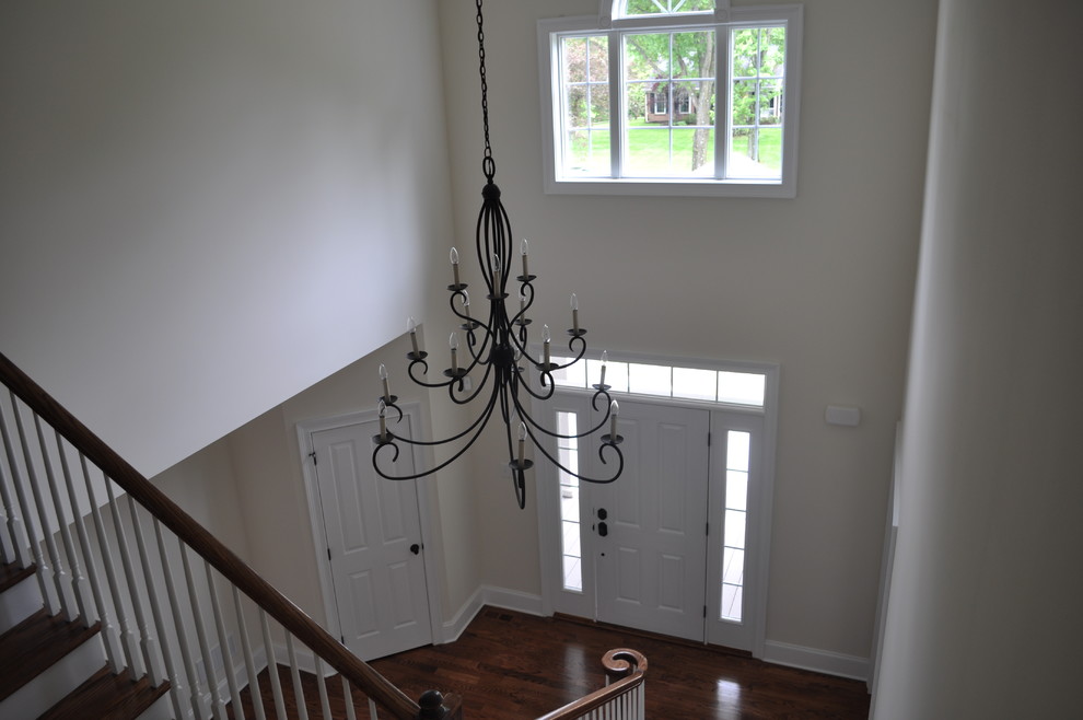 Photo of a large traditional foyer in Philadelphia with white walls, medium hardwood floors, a single front door and a white front door.
