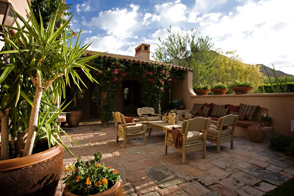 Inspiration for a mediterranean patio in Phoenix with natural stone pavers.