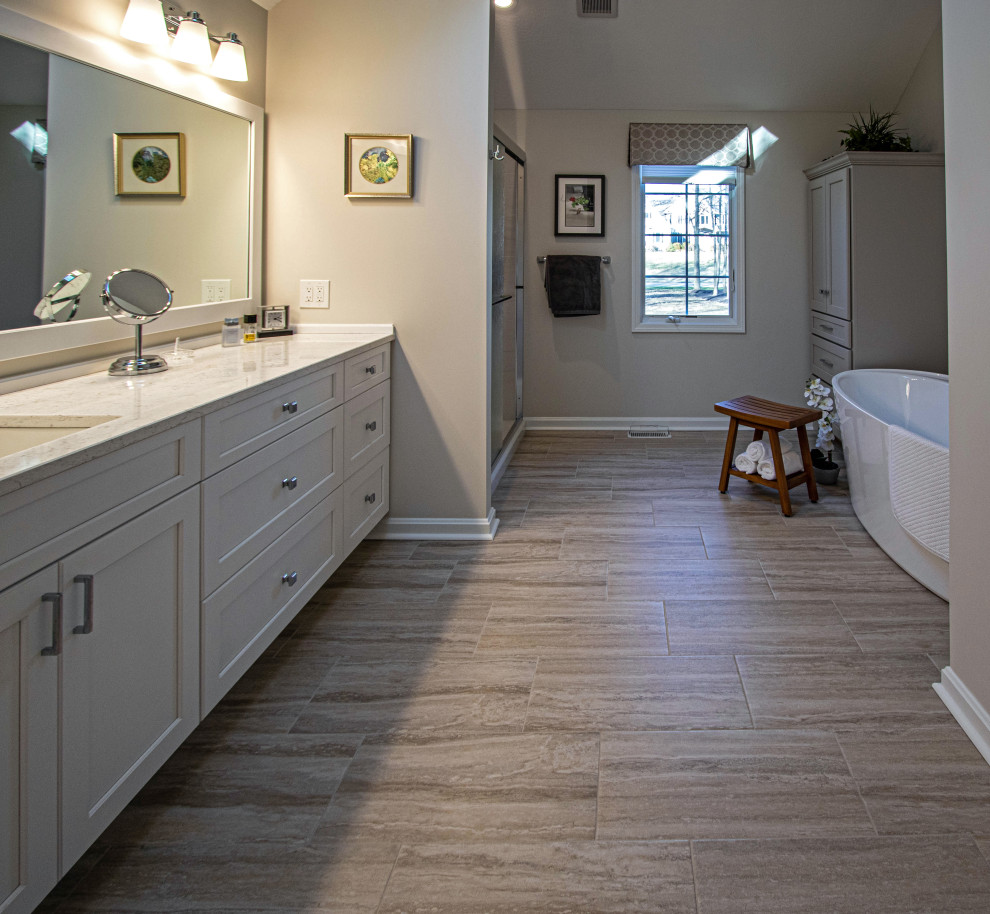 White Vanity with Freestanding Tub and Tiled Shower with Closet Storage
