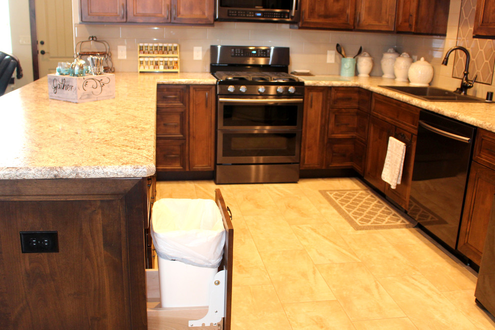 Inspiration for a transitional u-shaped porcelain tile eat-in kitchen remodel with flat-panel cabinets, medium tone wood cabinets, laminate countertops, beige backsplash and stainless steel appliances