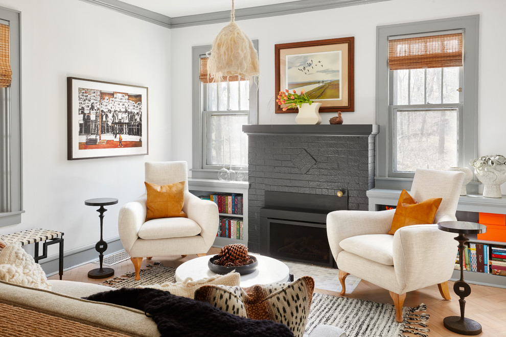 Design ideas for an eclectic formal living room in Chicago with grey walls, a standard fireplace and brown floor.