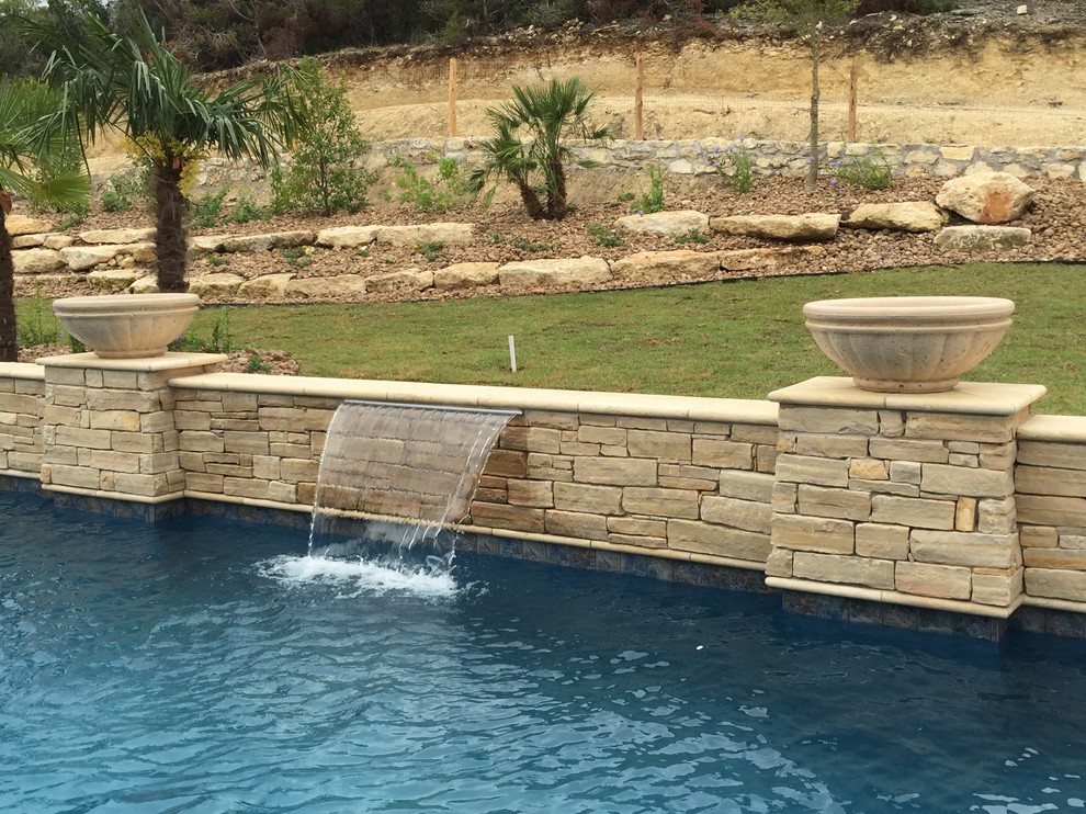 Design ideas for a mid-sized modern backyard rectangular lap pool in Austin with a water feature and decking.
