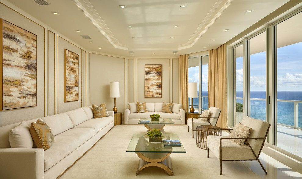 Photo of a large transitional open concept family room in Miami with beige walls, marble floors and a concealed tv.