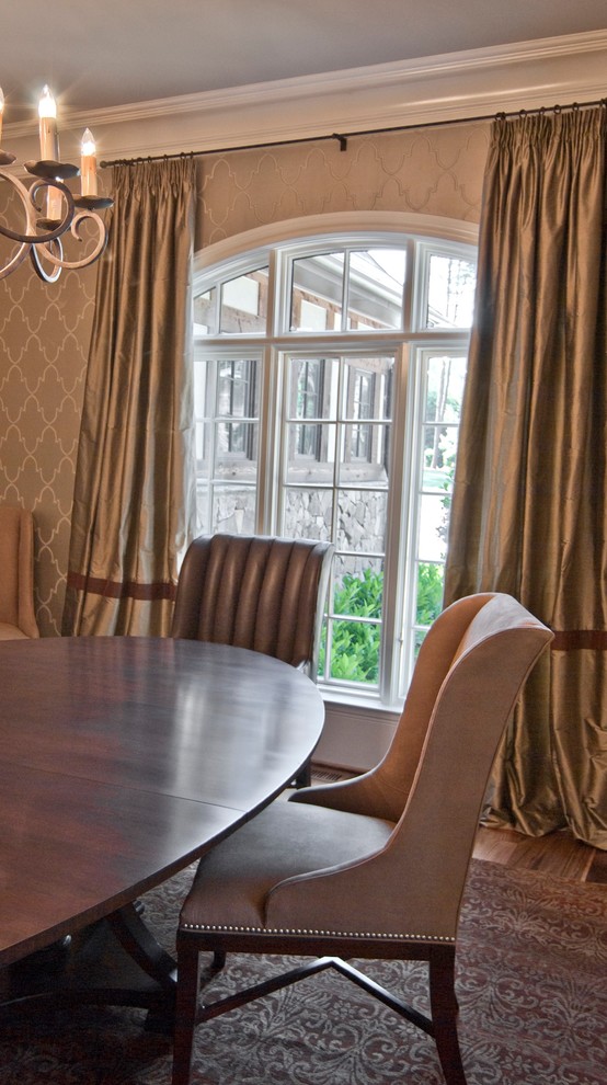 Photo of a traditional dining room in Charlotte with beige walls and medium hardwood floors.
