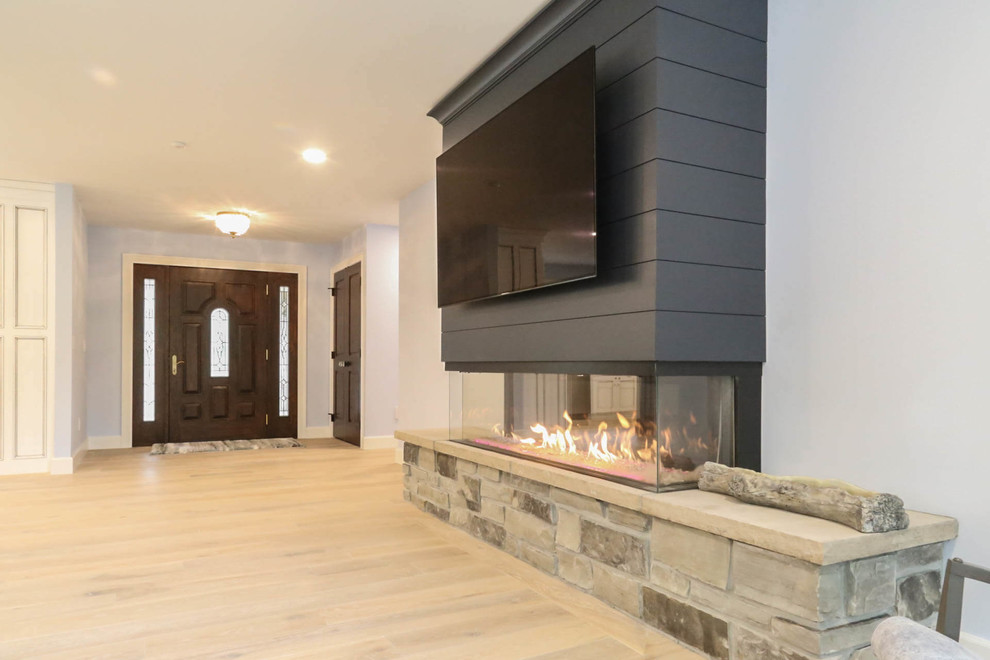 Inspiration for a mid-sized transitional light wood floor and beige floor front door remodel with blue walls and a medium wood front door