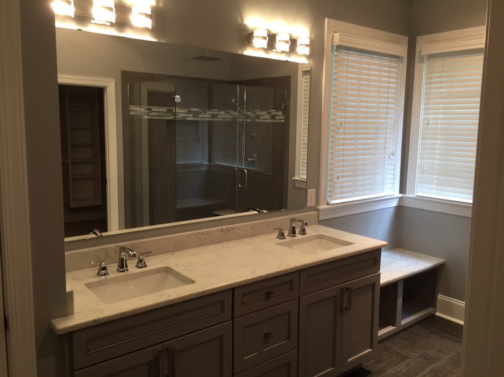 This is an example of a large contemporary master bathroom in Raleigh with flat-panel cabinets, grey cabinets, granite benchtops, gray tile, cement tile, a corner shower, an undermount sink, grey walls and ceramic floors.