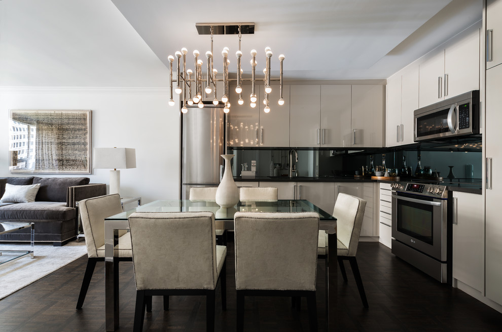 Design ideas for a small contemporary l-shaped open plan kitchen in Toronto with an undermount sink, flat-panel cabinets, grey cabinets, quartz benchtops, stainless steel appliances, dark hardwood floors, no island, black splashback and brown floor.