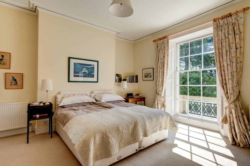 Photo of a traditional bedroom in Devon with beige walls, carpet and no fireplace.