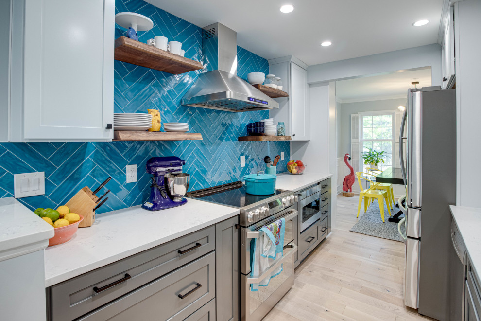Mid-sized transitional galley kitchen photo in DC Metro with an undermount sink, shaker cabinets, quartz countertops, blue backsplash, stainless steel appliances and no island