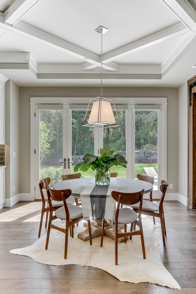 This is an example of a transitional dining room in Seattle with beige walls, medium hardwood floors and brown floor.