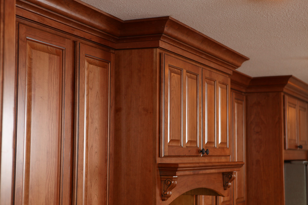 Design ideas for a traditional kitchen in Denver with raised-panel cabinets and light wood cabinets.