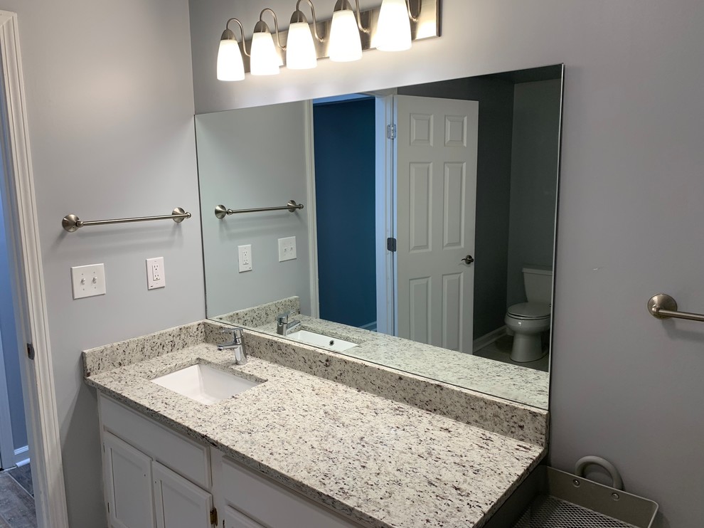 Inspiration for a mid-sized transitional master gray tile and marble tile porcelain tile and gray floor tub/shower combo remodel in Atlanta with a hot tub, gray walls and a hinged shower door