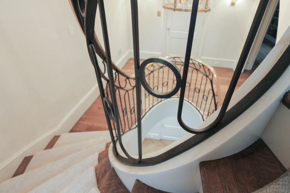Staircase - large transitional wooden curved metal railing staircase idea in DC Metro with wooden risers