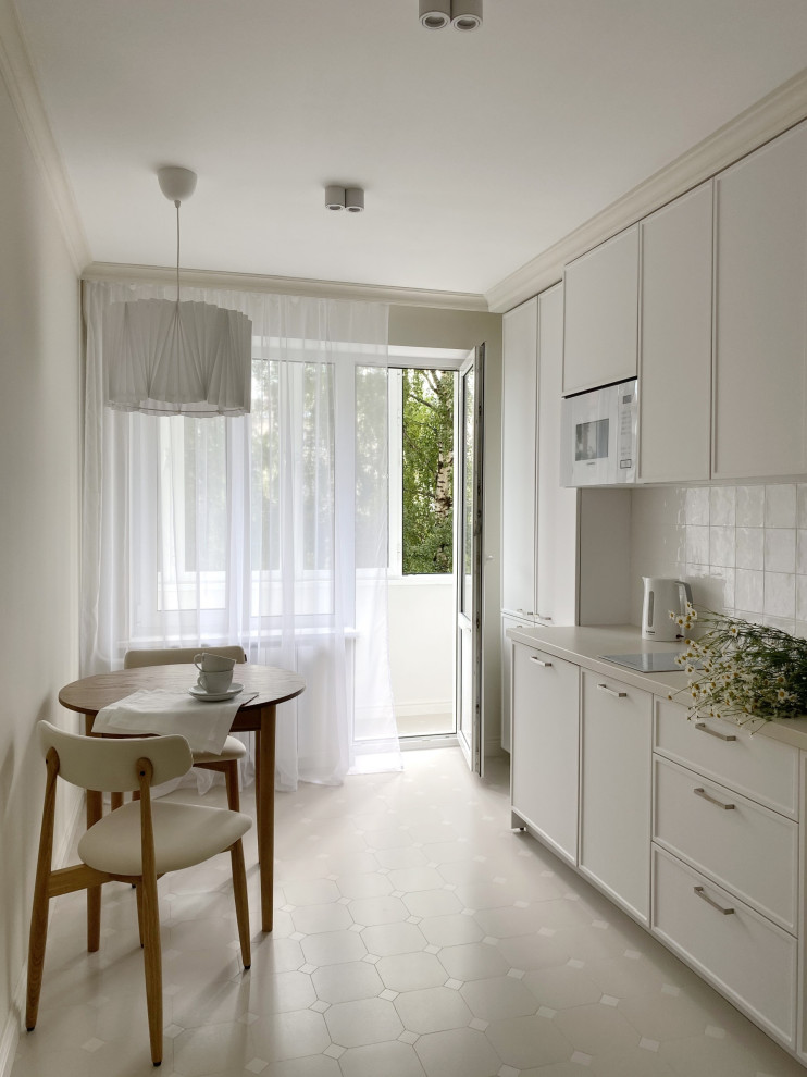 Photo of a small transitional single-wall separate kitchen in Moscow with a drop-in sink, beaded inset cabinets, white cabinets, laminate benchtops, white splashback, ceramic splashback, white appliances, porcelain floors, no island, beige floor and beige benchtop.