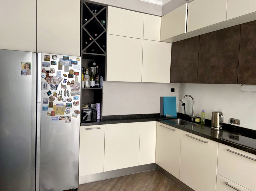 Inspiration for a large contemporary l-shaped eat-in kitchen in Moscow with an undermount sink, flat-panel cabinets, white cabinets, solid surface benchtops, white splashback, stainless steel appliances, porcelain floors, no island, multi-coloured floor, brown benchtop and recessed.