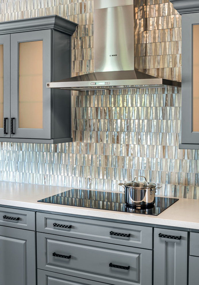 Example of a mid-sized transitional l-shaped limestone floor and beige floor kitchen design in Phoenix with a single-bowl sink, gray cabinets, quartz countertops, glass tile backsplash, stainless steel appliances, an island and white countertops