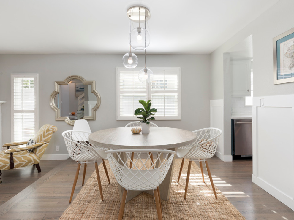 Small trendy wall paneling kitchen/dining room combo photo