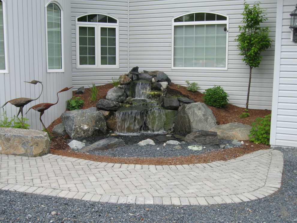 Inspiration for a large traditional backyard garden in Other with with pond.