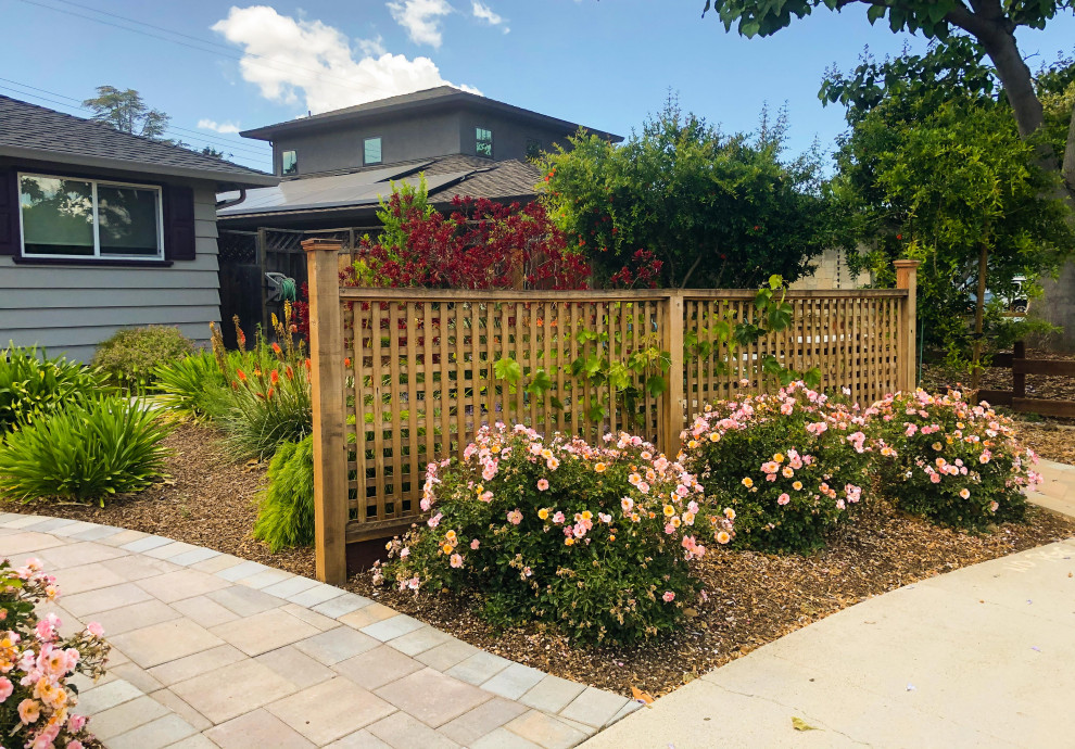 This is an example of an asian front yard full sun xeriscape in San Francisco with a garden path, concrete pavers and a wood fence.