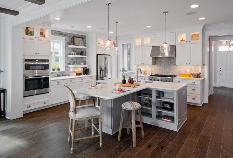 Transitional l-shaped eat-in kitchen in Charleston with a drop-in sink, white cabinets, stainless steel appliances, dark hardwood floors and with island.
