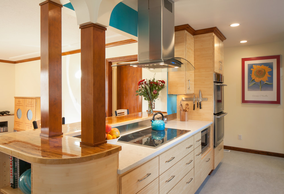 This is an example of an arts and crafts open plan kitchen in Portland with flat-panel cabinets, light wood cabinets, quartz benchtops, metallic splashback, metal splashback, stainless steel appliances and linoleum floors.