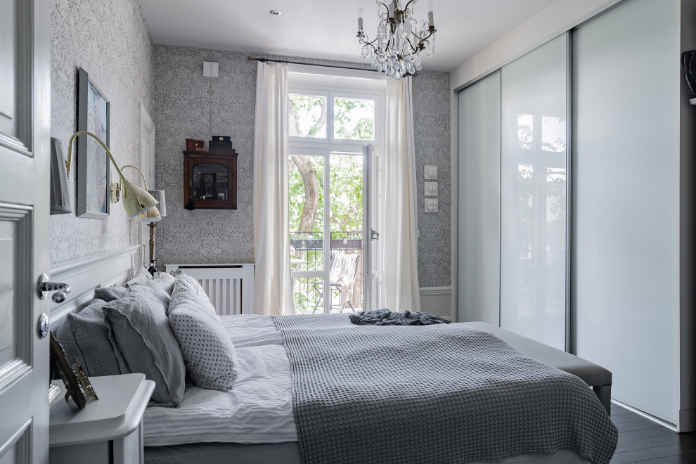 Mid-sized scandinavian bedroom in Stockholm with grey walls, dark hardwood floors, no fireplace and black floor.