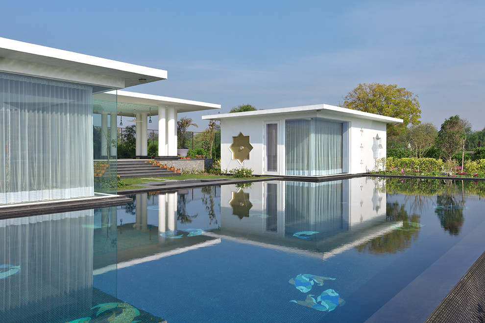 This is an example of a contemporary Custom-shaped swimming pool in Delhi.