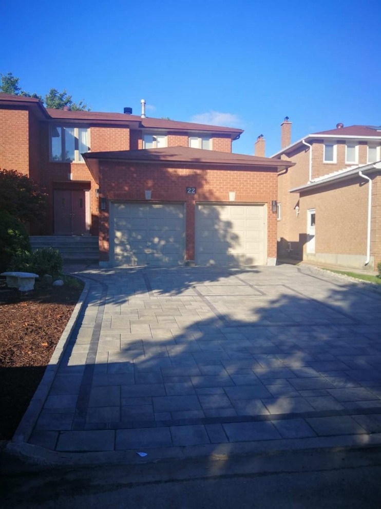Inspiration for a mid-sized contemporary front yard partial sun xeriscape in Toronto with concrete pavers.