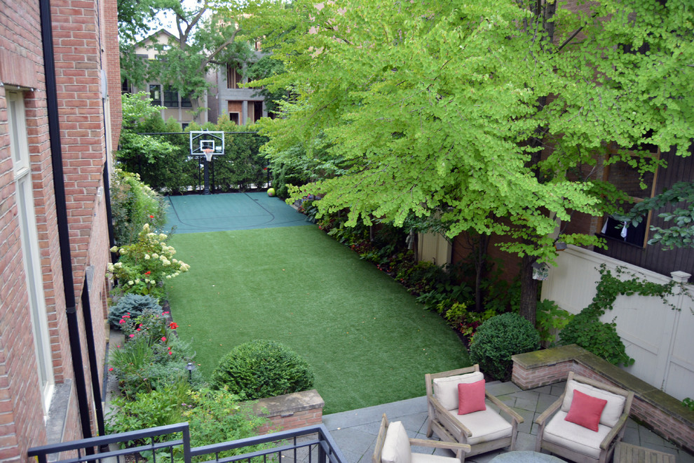 This is an example of a mid-sized contemporary backyard full sun outdoor sport court for spring in Chicago with a container garden and concrete pavers.