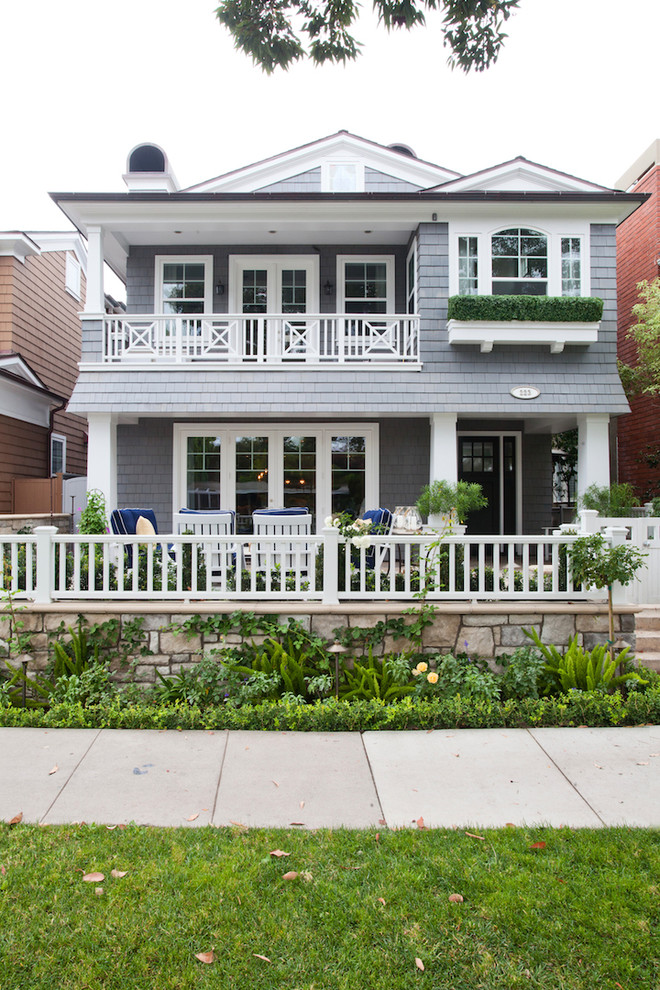 Inspiration for a large beach style two-storey grey exterior in Orange County with wood siding and a gable roof.