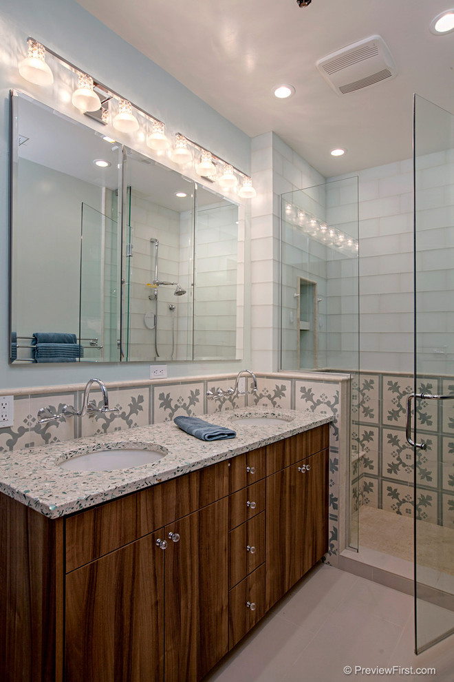 Photo of a mid-sized contemporary kids bathroom in San Diego with an undermount sink, flat-panel cabinets, dark wood cabinets, recycled glass benchtops, blue tile, ceramic tile, blue walls, ceramic floors and a wall-mount toilet.