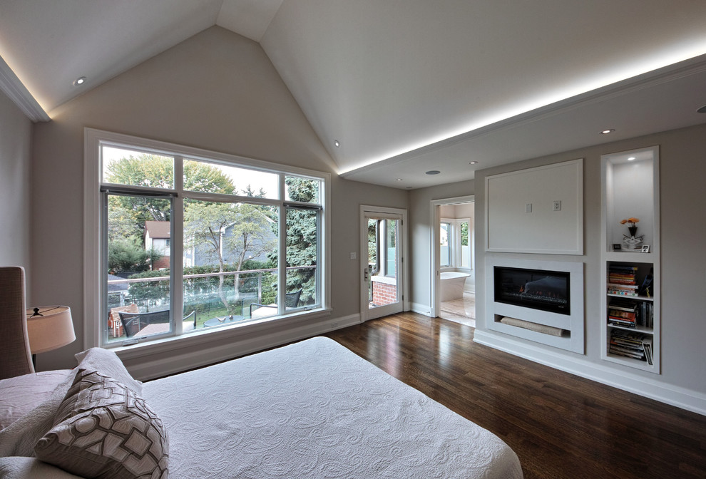 Inspiration for a mid-sized contemporary master bedroom in Toronto with white walls, medium hardwood floors, a ribbon fireplace, a stone fireplace surround and brown floor.