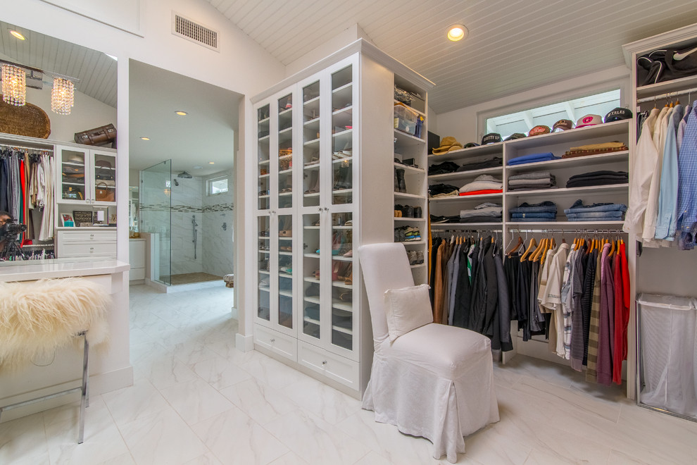 Large traditional gender-neutral walk-in wardrobe in Orange County with open cabinets, white cabinets and beige floor.